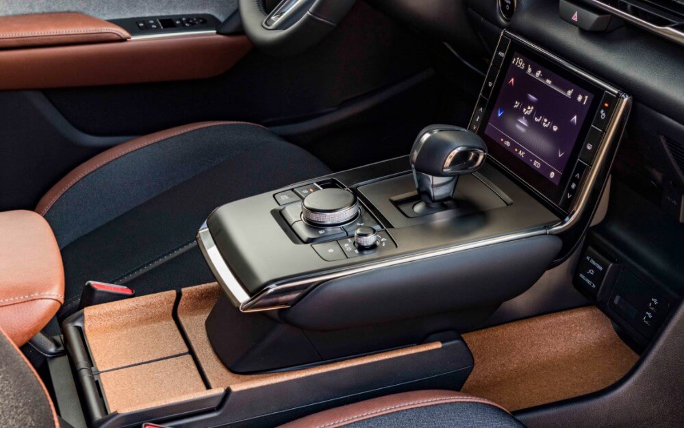 Center console inside the 2022 Mazda MX-30 SUV just purchased in Stuart, FL at Wallace Mazda.